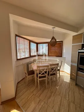 Kitchen with a dining table and chairs near the windows. - image 3