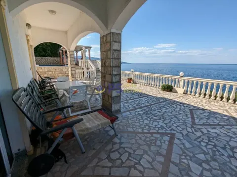 Spacious paved terrace with sea view and outdoor seating furniture. - image 18