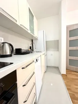 Smaller bright kitchen with built-in cabinetry and appliances. - image 7
