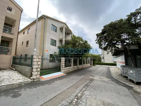 View of the exterior of the building with a fence and a surrounding street. - image 3