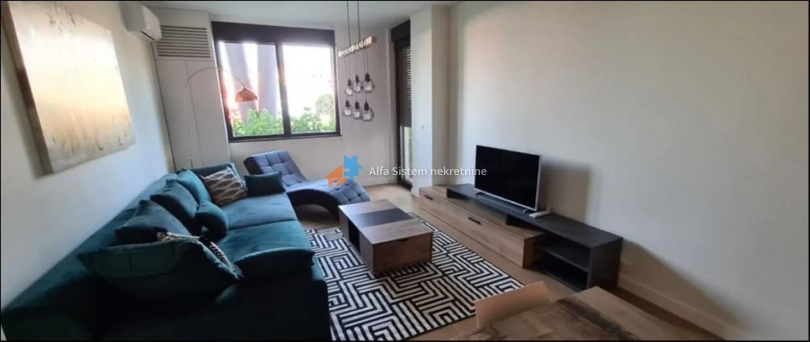Living room with sofa, coffee table and television.
