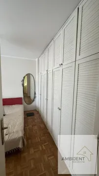 Small bedroom with a large white wardrobe and a bed. - image 13