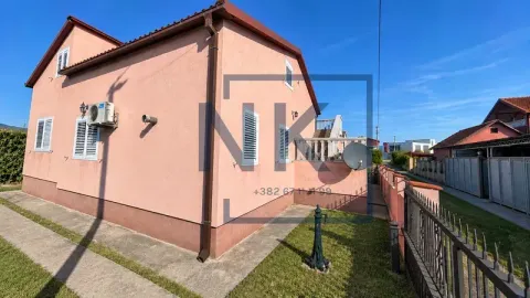 View of the exterior of the house with a yard and fence. - image 3