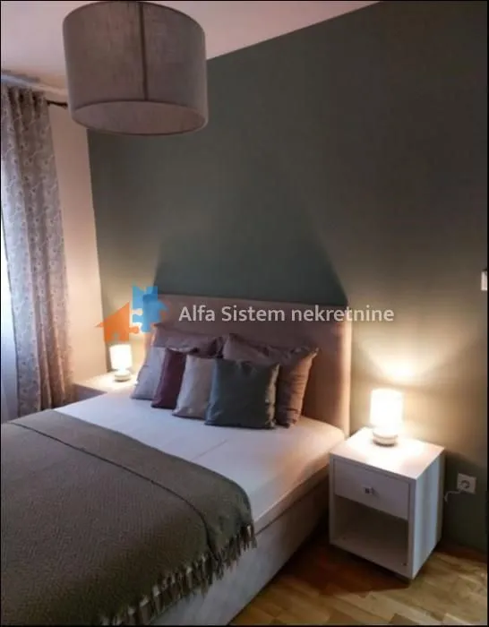 Furnished bedroom with a double bed and nightstands.