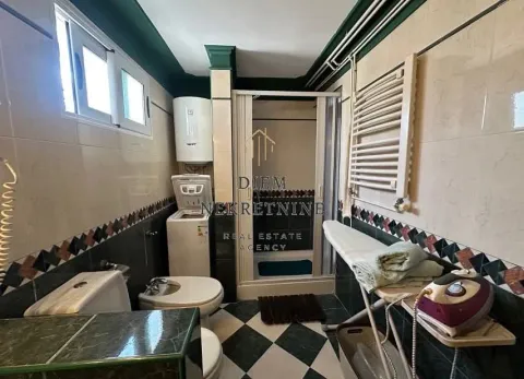 Cluttered bathroom with a shower cabin, washing machine, and sanitary fixtures. - image 8