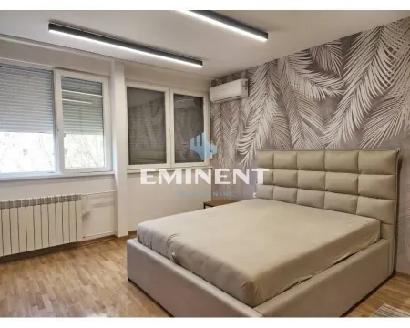 Furnished bedroom with a double bed and wallpaper on the wall. - image 6