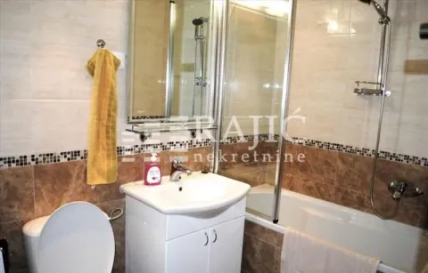Small bathroom with a sink, shower cabin, and sanitary fixtures. - image 12