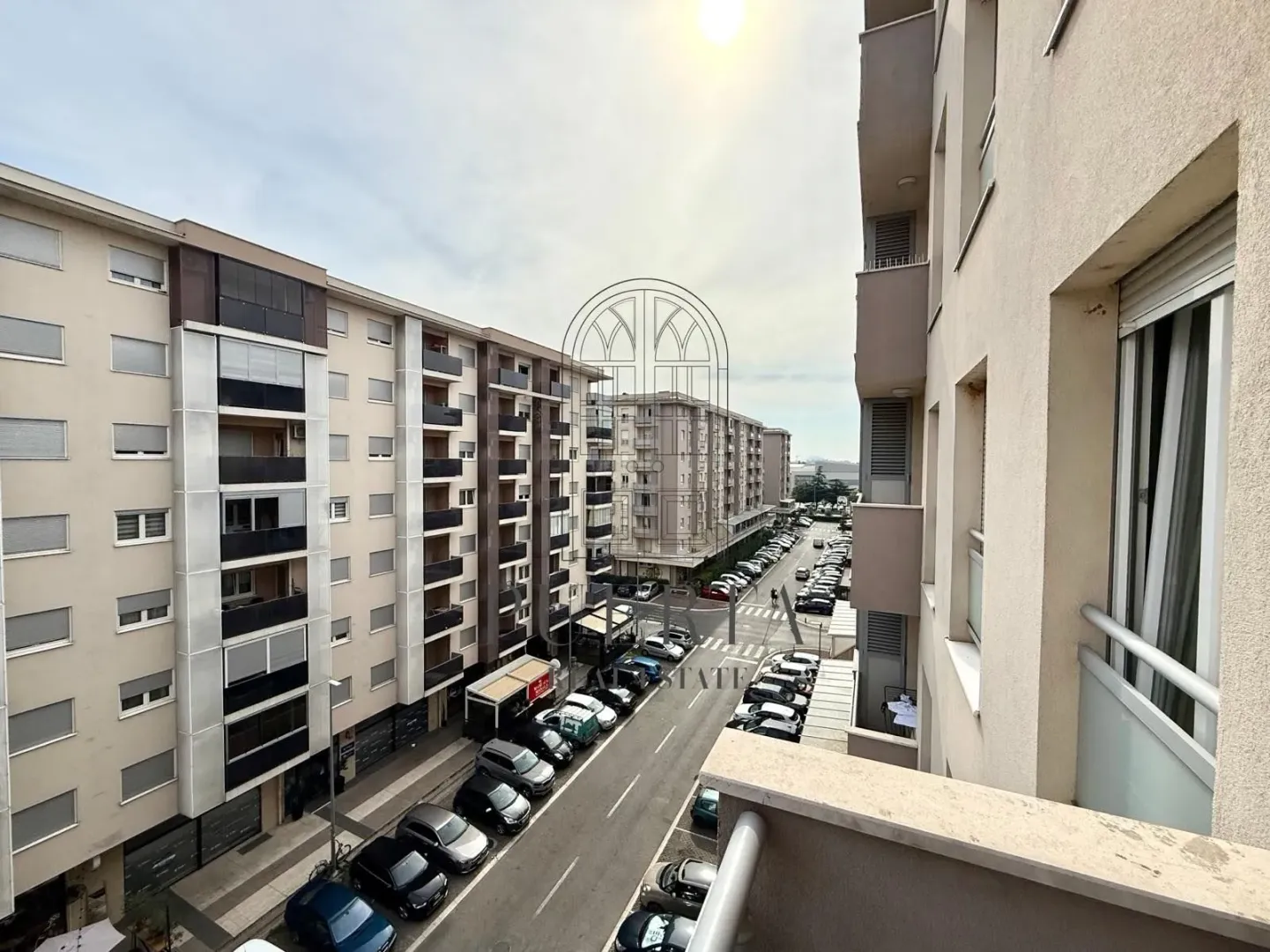 View from the terrace of the city street and surrounding buildings.