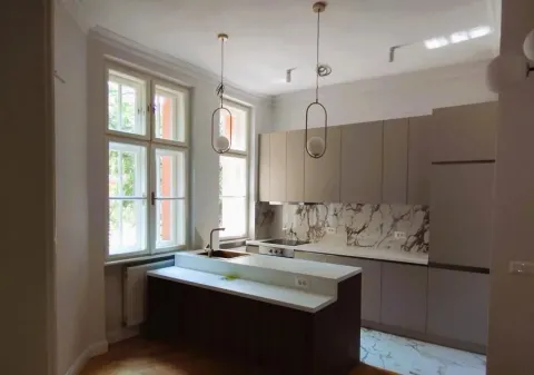 Modern kitchen with a kitchen island and windows providing natural lighting. - image 8