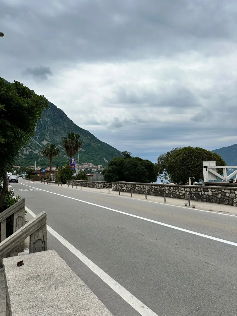 View of the street and nearby landscape with mountains.