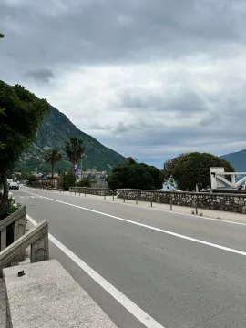 View of the street and nearby landscape with mountains. - image 12