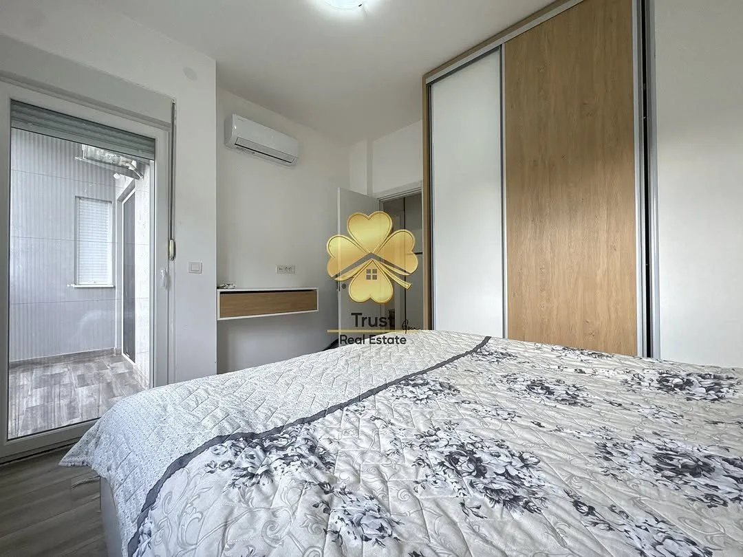Furnished bedroom with a large double bed, built-in wardrobe, and access to a terrace.