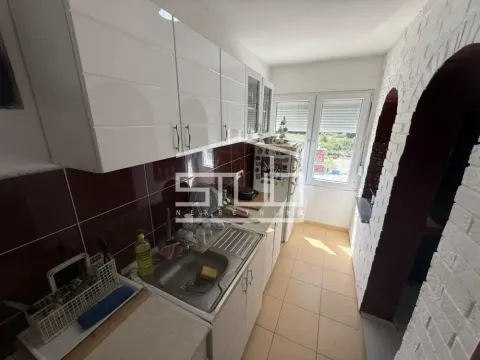 Manja kuhinja sa belim elementima i sudoperom pored prozora. - image 8