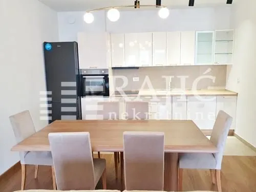 Modern kitchen with a dining table and chairs.