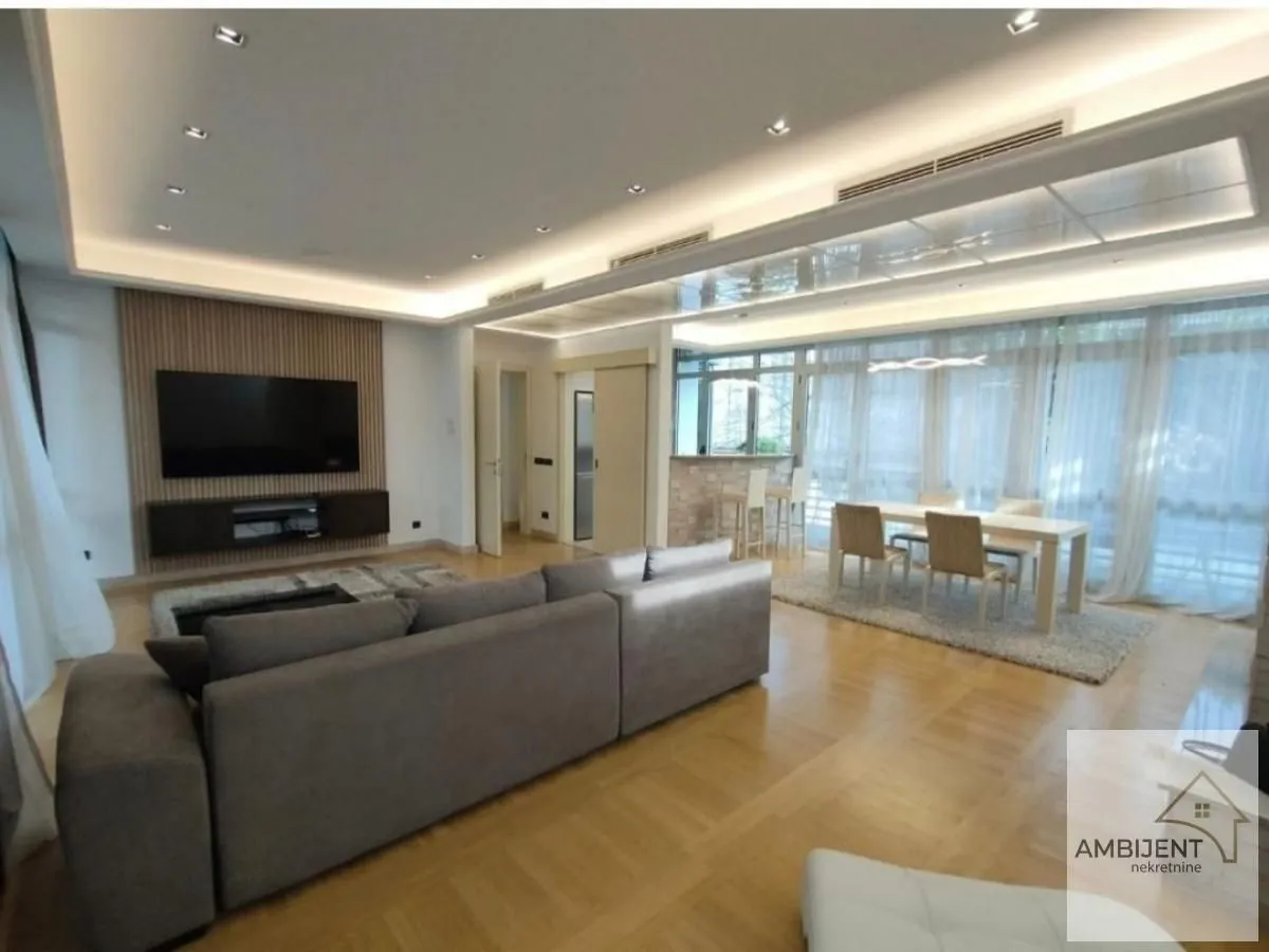 Spacious living room with a sofa set, dining area, and modern drop ceiling.