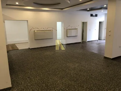 Spacious empty room with white walls and a drop ceiling. - image 2