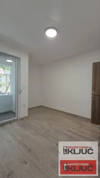 Prazna prostorija sa parketom i izlazom na terasu. - image 7