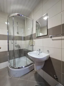 Bathroom with a shower cabin, washbasin, and mirror. - image 7