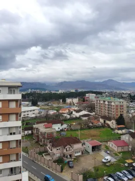 Elevated view of a city neighborhood and distant mountains. - image 10