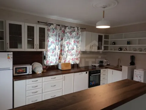 Spacious kitchen with white cabinetry and a dark countertop. - image 7