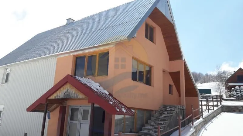 Exterior view of the house with snow in the surroundings.