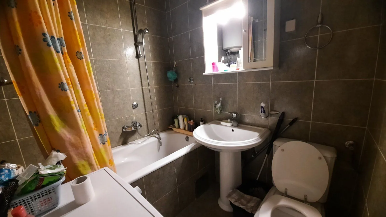Bathroom with a bathtub, sink, and toilet.