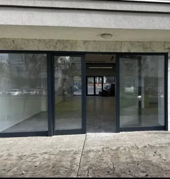 Entrance to a commercial space with a glass storefront. - image 8