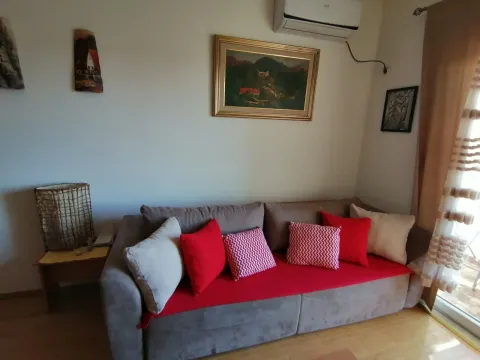 A living room featuring a comfortable sofa with decorative pillows and artwork on the wall. - image 6