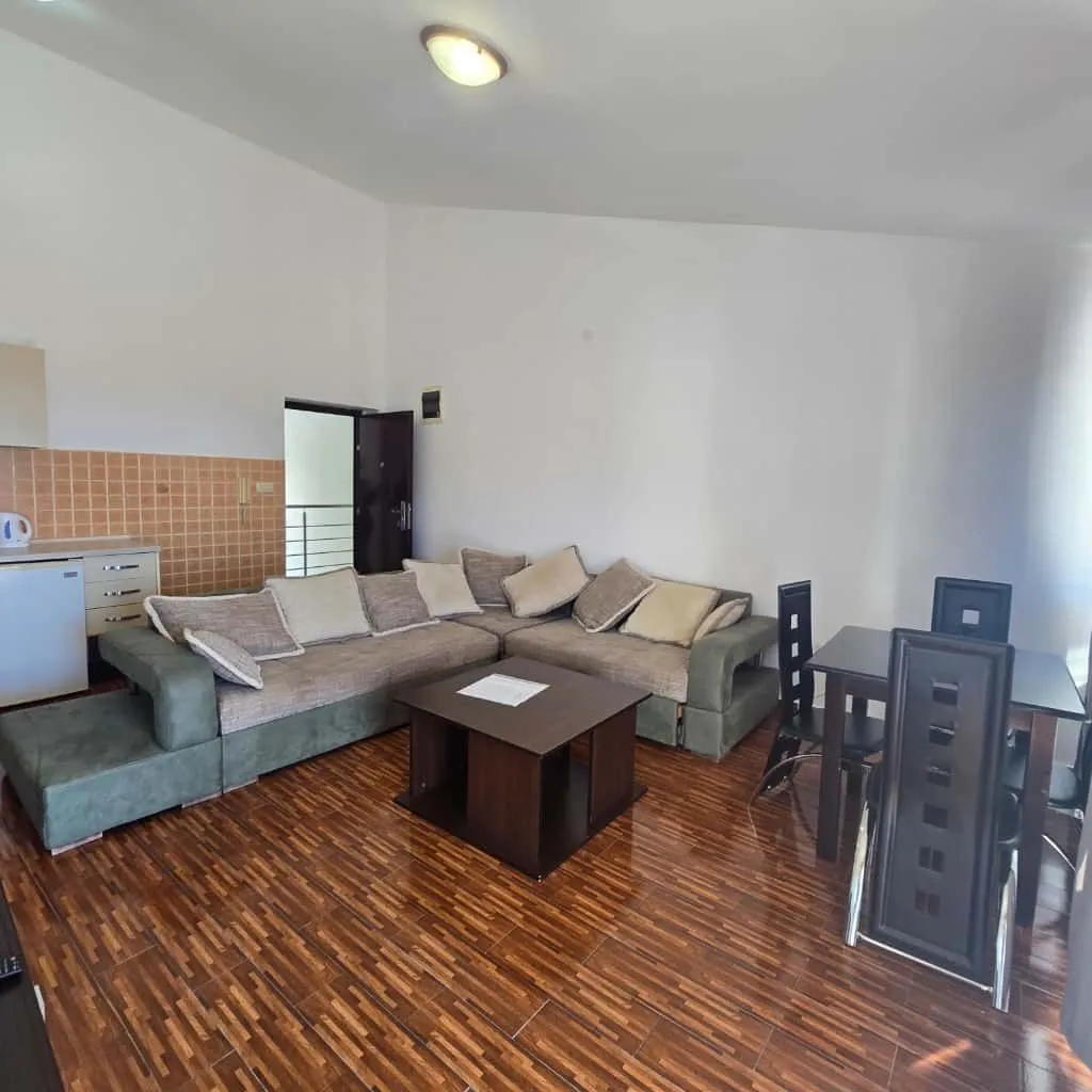 Living room with a sofa set, coffee table, and dining table.