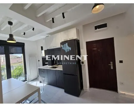 Modern kitchen with fitted units and a dining table by the window. - image 3