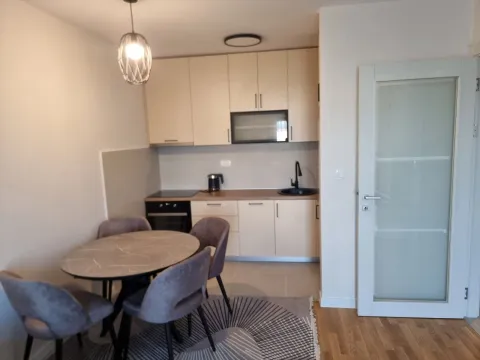 Modern kitchen with dining area and built-in appliances. - image 3