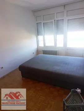 Bedroom with a double bed and parquet flooring. - image 16