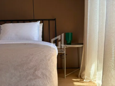 View of the bed and a bedside table with a lamp in the bedroom. - image 5