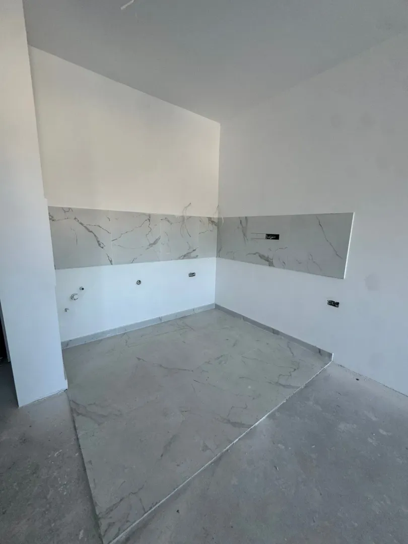 Nova kuhinja sa keramičkim pločicama i pripremljenim instalacijama.