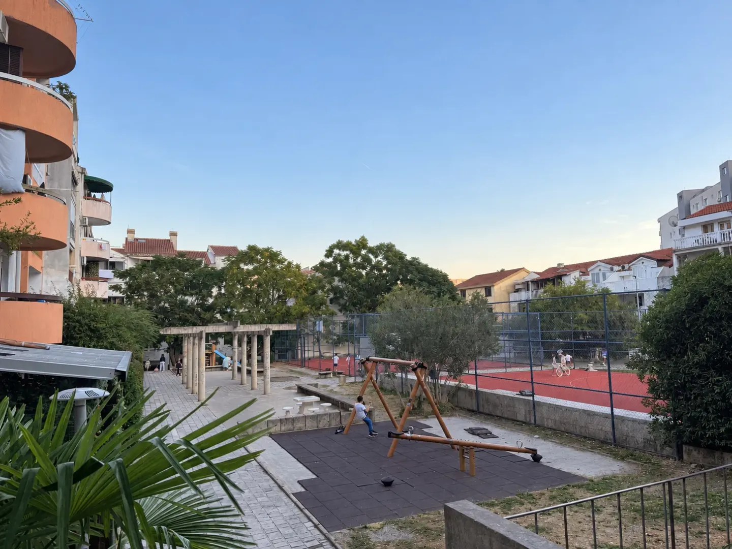 View from the terrace overlooking the courtyard and playground with sports courts.