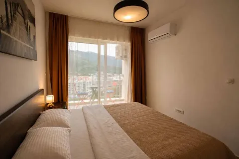 Furnished bedroom with a double bed, air conditioning, and a balcony with a view. - image 7