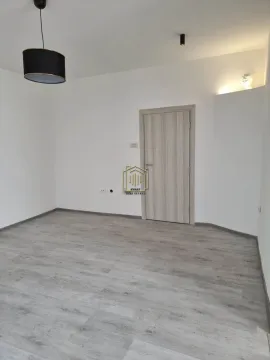 Empty room with laminate flooring and wooden door. - image 7