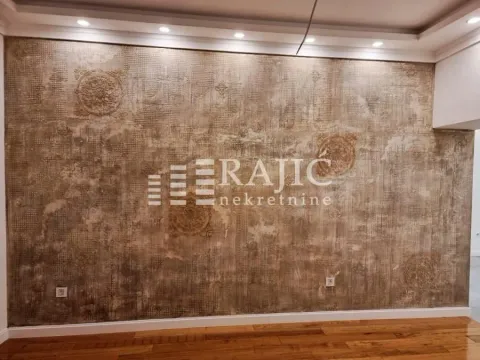 Interior space with a decorative wall and hardwood flooring. - image 7