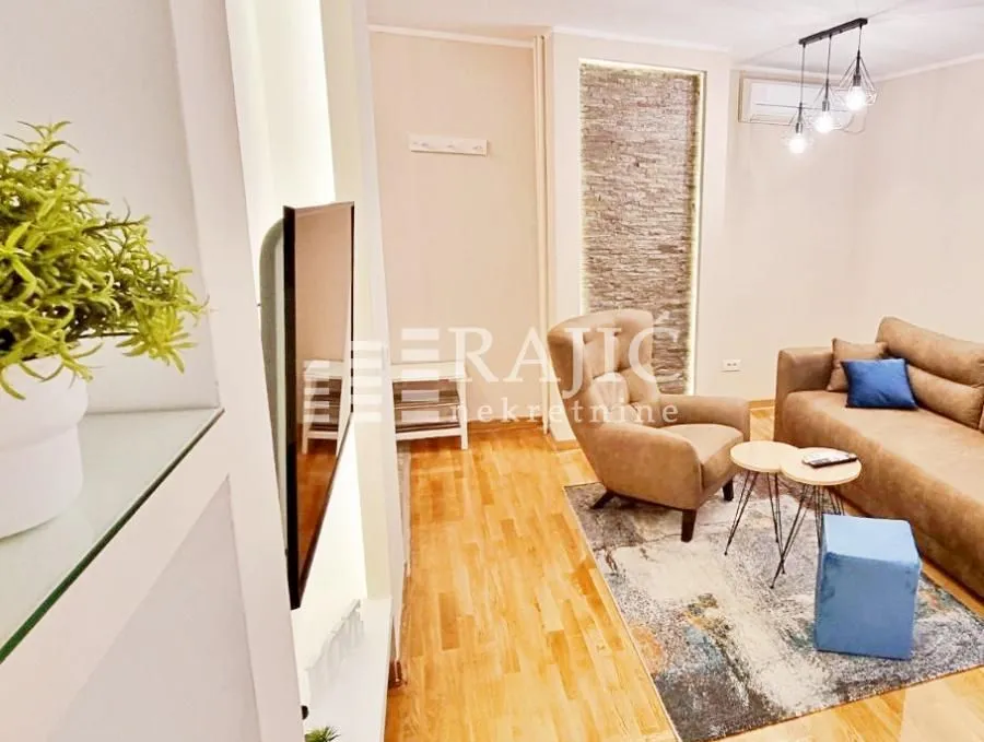Comfortable living room with a sofa and TV.