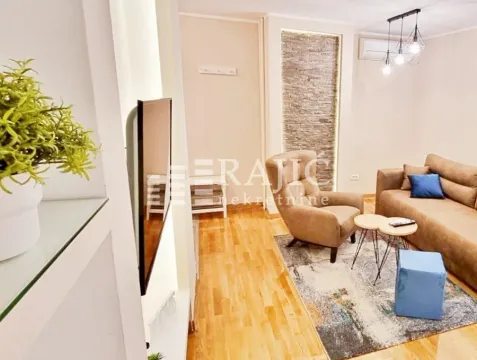 Comfortable living room with a sofa and TV. - image 16