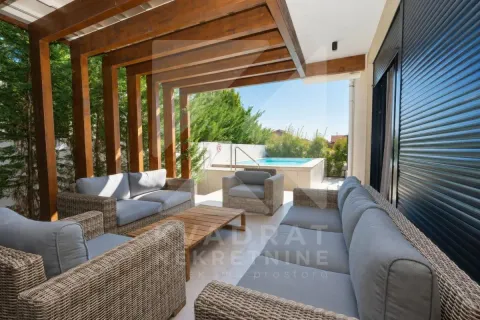 Covered terrace with seating furniture and a view of the pool. - image 25