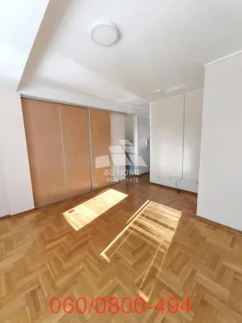 Empty bedroom with a built-in wardrobe and parquet flooring. - image 3