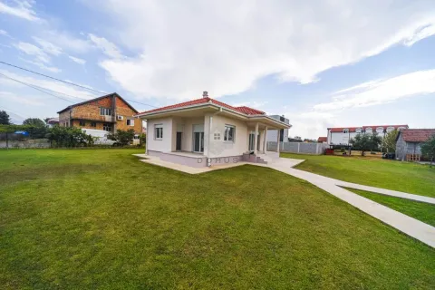 View of a ground-floor house with a spacious grassy yard and walkway. - image 10