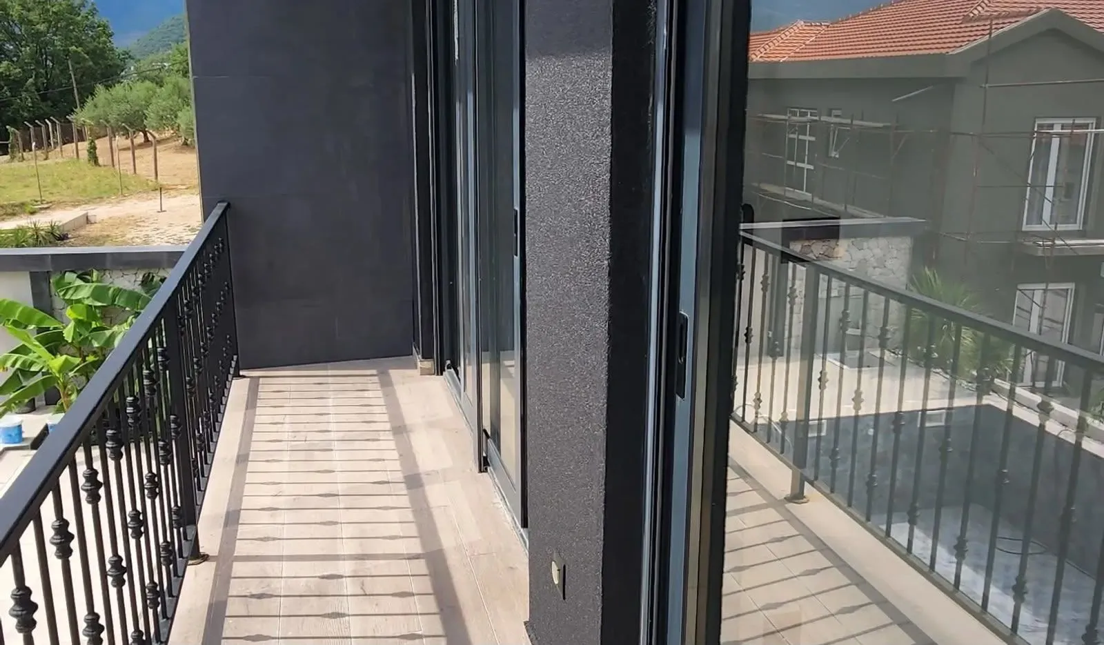 Modern balcony with a railing and a view of the surroundings.