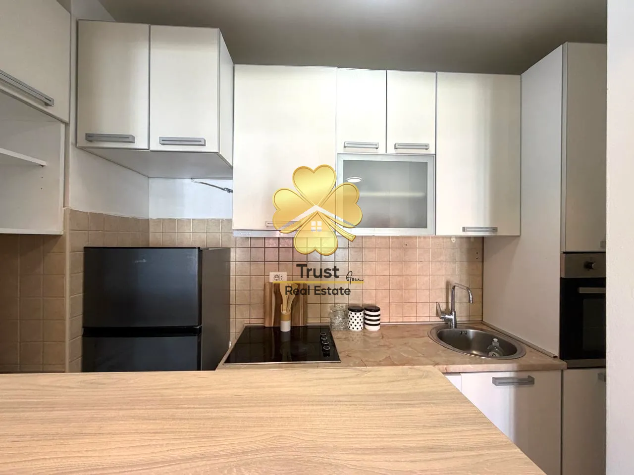 Small kitchen with white cabinets and a countertop.
