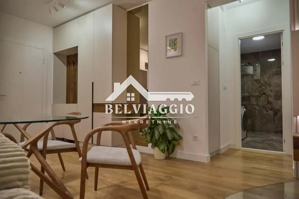 View of the living room with a dining table and chairs.