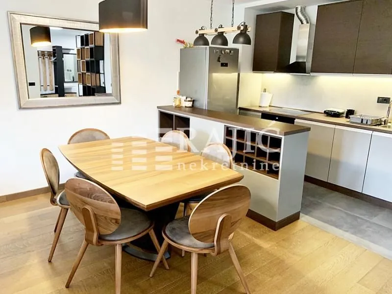 Modern kitchen with a dining area and built-in appliances.
