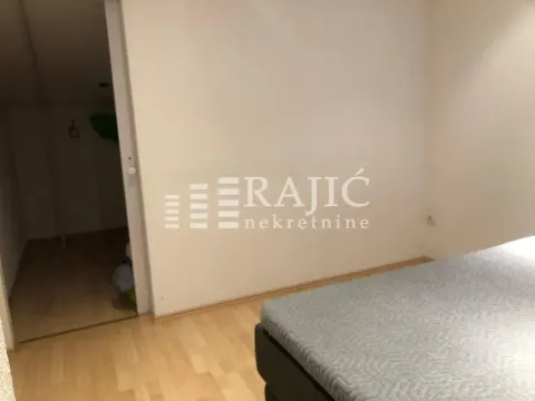 View of the bedroom with a double bed and hallway entrance. - image 11