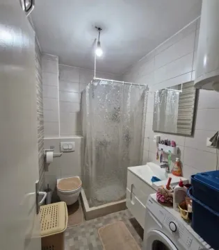 Manje opremljeno kupatilo sa tuš kabinom, umivaonikom i veš mašinom. - image 4