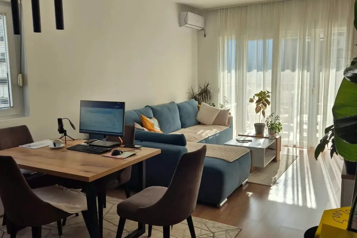 Living room with a sofa and dining table.